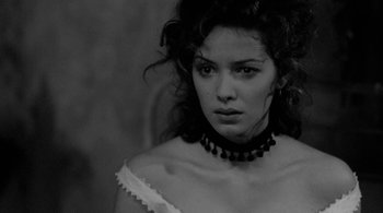 Movie still from “Dead Man” (1995), directed by Jim Jarmusch – A black and white photo of a woman in a white dress; Close Up shot, Over the shoulder angle