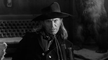 Movie still from “Dead Man” (1995), directed by Jim Jarmusch – A black and white photo of a man wearing a hat; Close Up shot, Low angle