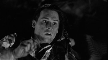 Movie still from “Dead Man” (1995), directed by Jim Jarmusch – A black and white photo of a man with long black hair; Close Up shot, Low angle