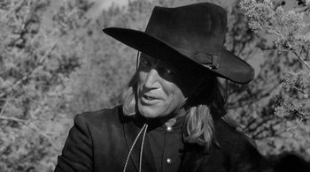 Movie still from “Dead Man” (1995), directed by Jim Jarmusch – A man in a cowboy hat and a jacket; Close Up shot, Low angle