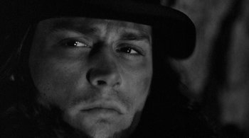 Movie still from “Dead Man” (1995), directed by Jim Jarmusch – A person wearing a hat; Close Up shot, Low angle