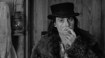 Movie still from “Dead Man” (1995), directed by Jim Jarmusch – A man in a top hat and fur coat; Close Up shot, High angle