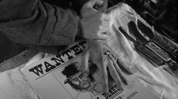 Movie still from “Dead Man” (1995), directed by Jim Jarmusch – A person is holding a cigarette in their hand; Extreme Close Up shot, Overhead angle