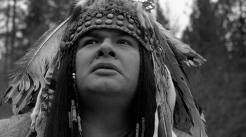 Movie still from “Dead Man” (1995), directed by Jim Jarmusch – A person wearing a headdress; Close Up shot, Low angle