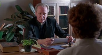 Movie still from “Dead Man Walking” (1995), directed by Tim Robbins – An older man sitting at a table with a woman; Close Up shot, Over the shoulder angle