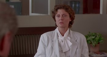 Movie still from “Dead Man Walking” (1995), directed by Tim Robbins – A woman wearing a white suit and a white bow tie; Close Up shot, Low angle