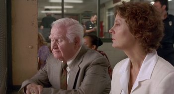 Movie still from “Dead Man Walking” (1995), directed by Tim Robbins – An older man and a younger woman sitting next to each other; Medium shot, Over the shoulder angle