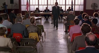 Movie still from “Dead Man Walking” (1995), directed by Tim Robbins – A group of people sitting in a room with chairs; Wide shot, High angle