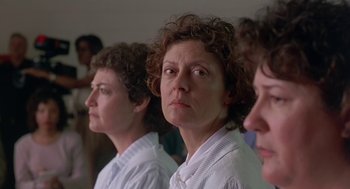 Movie still from “Dead Man Walking” (1995), directed by Tim Robbins – A group of women standing next to each other in a room; Close Up shot, Over the shoulder angle