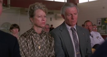 Movie still from “Dead Man Walking” (1995), directed by Tim Robbins – An older man and a younger woman standing next to each other; Close Up shot, Low angle