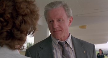 Movie still from “Dead Man Walking” (1995), directed by Tim Robbins – An older man wearing a suit and striped tie; Close Up shot, Low angle