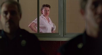 Movie still from “Dead Man Walking” (1995), directed by Tim Robbins – A woman standing in front of an open window; Medium shot, Low angle