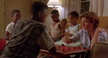 Movie still from “Dead Man Walking” (1995), directed by Tim Robbins – A group of children playing a game of checkers; Medium shot, High angle