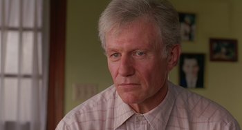 Movie still from “Dead Man Walking” (1995), directed by Tim Robbins – An older man wearing a pink and white checkered shirt; Close Up shot, Low angle