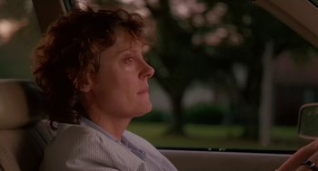 Movie still from “Dead Man Walking” (1995), directed by Tim Robbins – A woman sitting in the back seat of a car with her eyes closed; Close Up shot, Low angle