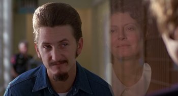 Movie still from “Dead Man Walking” (1995), directed by Tim Robbins – A man with a beard standing next to a woman; Close Up shot, Over the shoulder angle