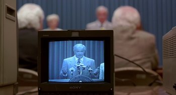 Movie still from “Dead Man Walking” (1995), directed by Tim Robbins – A man is giving a speech in front of a group of people; Extreme Close Up shot, Over the shoulder angle