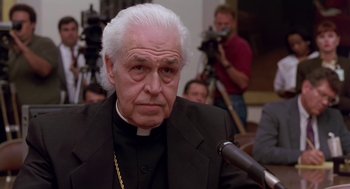 Movie still from “Dead Man Walking” (1995), directed by Tim Robbins – An older man in a black suit and white hair; Close Up shot, Low angle