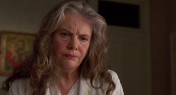 Movie still from “Dead Man Walking” (1995), directed by Tim Robbins – An older woman with long gray hair looking at the camera; Close Up shot, Low angle