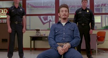 Movie still from “Dead Man Walking” (1995), directed by Tim Robbins – A man sitting in a chair with a handcuffs on his hands; Medium shot, Over the shoulder angle