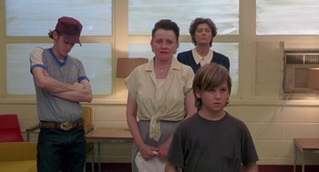 Movie still from “Dead Man Walking” (1995), directed by Tim Robbins – A group of people standing in front of a window; Medium shot, Low angle