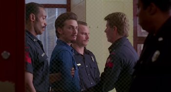 Movie still from “Dead Man Walking” (1995), directed by Tim Robbins – A group of men standing next to each other; Medium shot, Over the shoulder angle