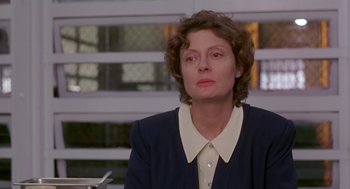 Movie still from “Dead Man Walking” (1995), directed by Tim Robbins – A woman in a blue jacket is sitting at a table; Close Up shot, Low angle