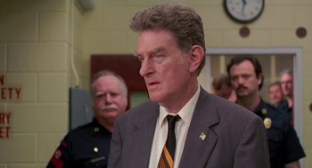 Movie still from “Dead Man Walking” (1995), directed by Tim Robbins – A person wearing a suit and tie; Close Up shot, Over the shoulder angle