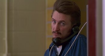 Movie still from “Dead Man Walking” (1995), directed by Tim Robbins – A man with a beard is talking on a phone; Close Up shot, Low angle