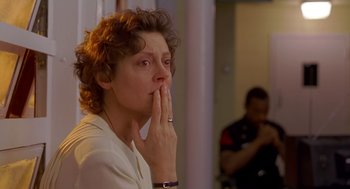 Movie still from “Dead Man Walking” (1995), directed by Tim Robbins – A woman with her hands over her mouth; Close Up shot, Low angle