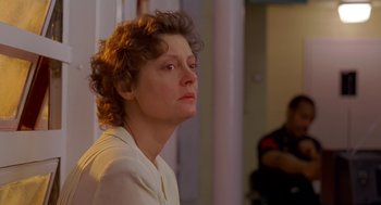 Movie still from “Dead Man Walking” (1995), directed by Tim Robbins – A woman with curly red hair is looking to her left; Close Up shot, Over the shoulder angle