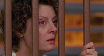 Movie still from “Dead Man Walking” (1995), directed by Tim Robbins – A person behind a metal fence; Close Up shot, High angle
