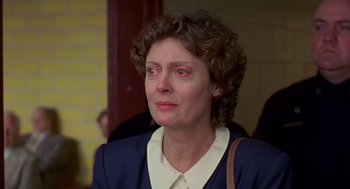 Movie still from “Dead Man Walking” (1995), directed by Tim Robbins – An older woman with curly brown hair wearing a white shirt and a blue jacket; Close Up shot, Low angle