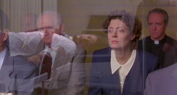 Movie still from “Dead Man Walking” (1995), directed by Tim Robbins – A woman and a man are looking out of a window; Medium shot, Over the shoulder angle