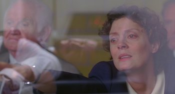 Movie still from “Dead Man Walking” (1995), directed by Tim Robbins – A woman sitting in front of a glass window; Close Up shot, Over the shoulder angle