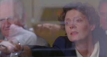 Movie still from “Dead Man Walking” (1995), directed by Tim Robbins – An older woman sitting in front of a glass window; Close Up shot, Low angle