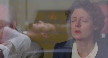 Movie still from “Dead Man Walking” (1995), directed by Tim Robbins – A woman sitting in front of a man in a suit; Close Up shot, Over the shoulder angle