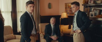 Movie still from “Dirty Grandpa” (2016), directed by Dan Mazer – A man in a suit sitting in front of another man in a suit; Medium shot, Over the shoulder angle