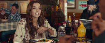 Movie still from “Dirty Grandpa” (2016), directed by Dan Mazer – A woman sitting at a table with a plate of food in front of her; Close Up shot, Over the shoulder angle