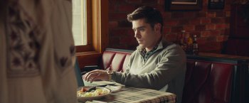 Movie still from “Dirty Grandpa” (2016), directed by Dan Mazer – A man sitting in front of a plate of food; Medium shot, Over the shoulder angle