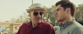 Movie still from “Dirty Grandpa” (2016), directed by Dan Mazer – An older man wearing sunglasses and a hat; Close Up shot, Over the shoulder angle