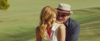 Movie still from “Dirty Grandpa” (2016), directed by Dan Mazer – An older man and a young woman are hugging outside; Medium shot, Low angle