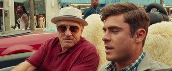 Movie still from “Dirty Grandpa” (2016), directed by Dan Mazer – A man in a hat and sunglasses sitting next to another man; Close Up shot, Over the shoulder angle