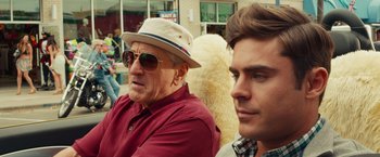 Movie still from “Dirty Grandpa” (2016), directed by Dan Mazer – A man wearing a hat sitting next to another man wearing sunglasses; Close Up shot, Over the shoulder angle