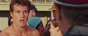 Movie still from “Dirty Grandpa” (2016), directed by Dan Mazer – A group of people standing next to each other on the beach; Close Up shot, Over the shoulder angle
