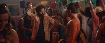 Movie still from “Dirty Grandpa” (2016), directed by Dan Mazer – A group of young men standing around a room; Medium shot, Over the shoulder angle