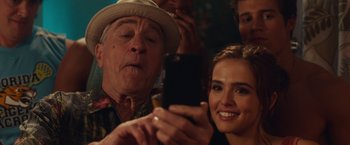 Movie still from “Dirty Grandpa” (2016), directed by Dan Mazer – An older man and a young woman looking at a cell phone; Close Up shot, Over the shoulder angle