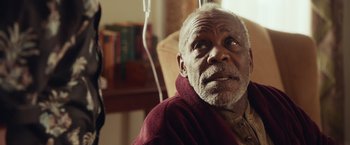 Movie still from “Dirty Grandpa” (2016), directed by Dan Mazer – An older man sitting in a chair with a red blanket; Close Up shot, Over the shoulder angle