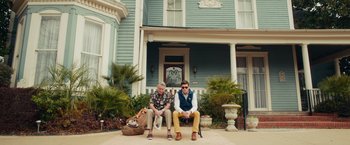 Movie still from “Dirty Grandpa” (2016), directed by Dan Mazer – Two men sitting in front of a house; Wide shot, Low angle
