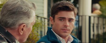 Movie still from “Dirty Grandpa” (2016), directed by Dan Mazer – A man in a blue vest is looking to his left; Close Up shot, Over the shoulder angle